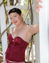 Outdoor pics with short-haired dame taking red lingerie off