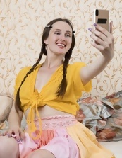 Pretty mom with pigtails takes pictures of herself being naked