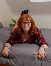 Mature redhead with glasses receives pleasure thanks to the dildo