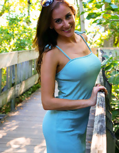 Cheerful woman in blue dress flashes pussy in public place