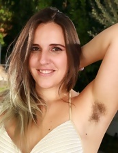 Chubby lady demonstrates hairy armpits and pussy by the pool