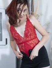Skinny redhead with small tits showing her bush on the camera