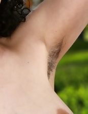 Hottie with glasses shows natural tits and hairy pussy outdoors