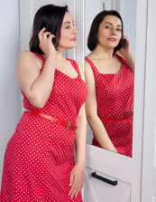 Joyful mature frees body from red dress and shows her assets