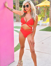 Stunning blond MILF in red bikini relaxes solo near public pool