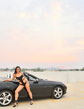 Hot MILF poses near car dressed in sexy lingerie