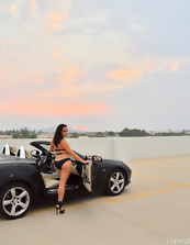 Hot MILF poses near car dressed in sexy lingerie