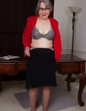 Mature secretary shows her saggy tits and hairy pussy