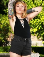 Outdoor pics of inked minx with small tits pissing