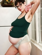 Pregnant mom with glasses displays bush in solo pics
