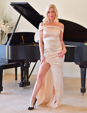Hot blonde strips naked by piano in MILF porn pics
