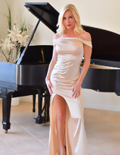 Hot blonde strips naked by piano in MILF porn pics