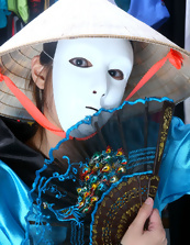 Fit and hot Asian brunette is wearing a mask and a kimono