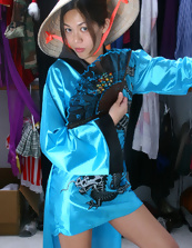 Fit and hot Asian brunette is wearing a mask and a kimono