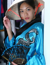 Fit and hot Asian brunette is wearing a mask and a kimono
