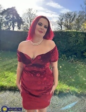 One mature nude redhead wearing the sluttiest dress