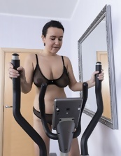 MILF with sagging boobs works out naked on the exercise bike.