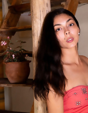 Short cutie with long hair posing next to the guitar