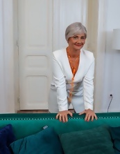 Mature wench wears panties and she smiles while posing her ass