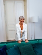 Mature wench wears panties and she smiles while posing her ass