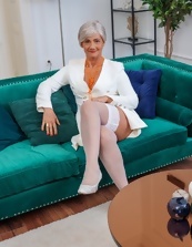 Mature wench wears panties and she smiles while posing her ass