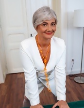 Mature wench wears panties and she smiles while posing her ass