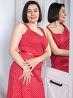 Joyful mature frees body from red dress and shows her assets