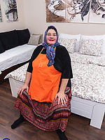 Mature granny in orange apron teasing underwear next to babe in pink cheerleader outfit