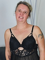 Mature lady spreads wide in sheer black outfit