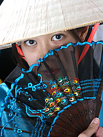 Fit and hot Asian brunette is wearing a mask and a kimono