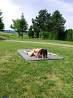 Outdoor milf licking hairy pussy in the grass