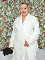 Mature nude tease in tub with shaved pussy and natural tits in spread pose