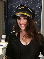 Hot stewardess in uniform spreads long legs in stockings