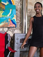 Slender ebony babe strips naked and shows her bush