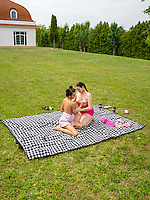 Outdoor nude trio on blanket in spread pose with fingering pussy in raw lesbian action