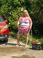 Mature babe washes car in pink shorts and teases curvy big booty in tight mini skirt