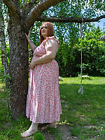 Mature redhead sheds floral dress outdoors for solo tease with tits out and big booty