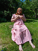 Mature redhead sheds floral dress outdoors for solo tease with tits out and big booty