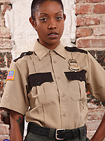 Nude black babe with tattoos poses after removing her uniform