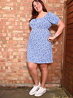 Mature brunette milf in blue dress teases with natural tits, hairy pussy, spread pose